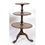 A George III mahogany three tier dumb waiter, on a tripod base, 60 cm diameter See illustration