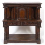 A 17th century style carved oak buffet, having a panel door, geometric carved drawer, and an