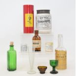 A collection of medical apothecary items, including bottles, measures, jars, syringes and a Cuckoo