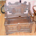 An oak box settle, with carved decoration, 85 cm wide