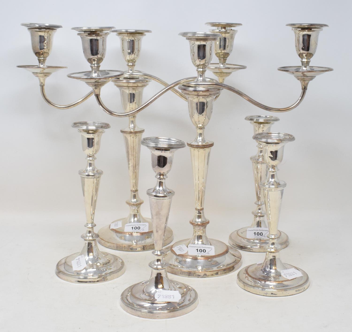 A pair of plated on copper three light candelabra, crested, and a set of four similar table