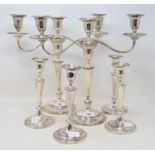 A pair of plated on copper three light candelabra, crested, and a set of four similar table