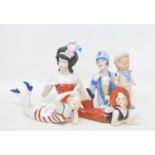 A porcelain figure of a bather, 16.5 cm wide, and four other figures (5) Modern