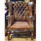 A leather upholstered wingback armchair, damages and lacks seat From a local care home. It lacks its