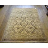 An Eastern rug, decorated geometric motifs on a beige ground, within a multi border, 183 x 126 cm