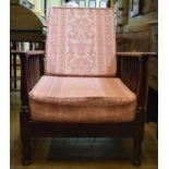 An Arts & Crafts oak reclining armchair, on baluster turned legs
