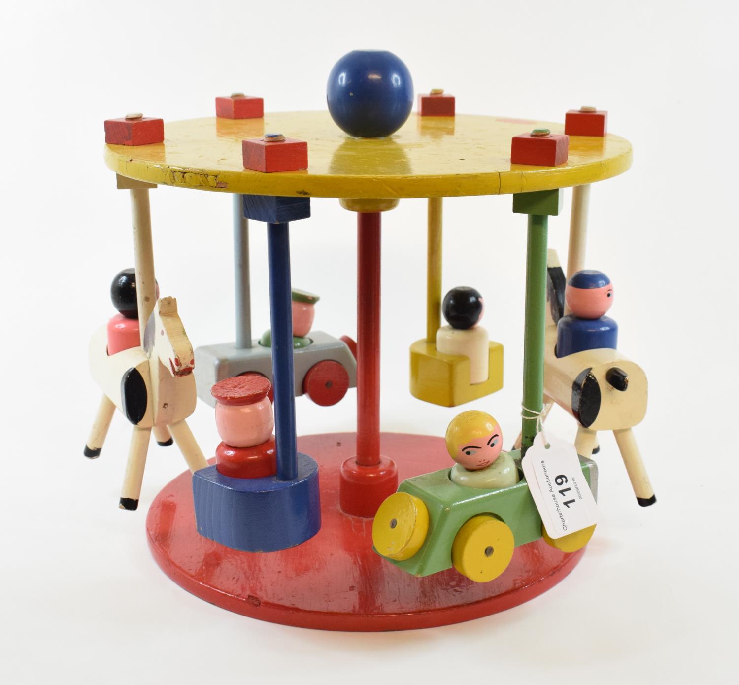 An Escor painted wood child's carousel, with cars and horses, 23 cm high