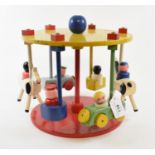 An Escor painted wood child's carousel, with cars and horses, 23 cm high