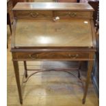 An Edwardian inlaid mahogany cylinder desk, on tapering square legs joined by a shaped undertier, 75
