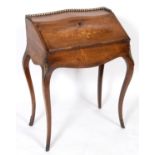 A French rosewood bonheur du jour, with a brass three quarter gallery and fall front with floral