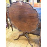 A mahogany tripod table, with a piecrust top, a fluted and reeded vase turned column and leaf carved