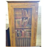 A pine cupboard, with an oak paint effect, the door painted books, 92 cm wide Door bowed. Lacks left