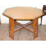 A Gothic style oak octagonal table, the supports with pierced decoration, 126 cm wide
