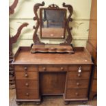A Victorian mahogany dressing table, having an arrangement of nine drawers around a central