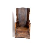 A 19th century pine wingback lambing chair, with a drawer to the base See illustration Report GH
