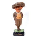 An early 20th century painted wood advertising figure, in the form of a golfer smoking a pipe,