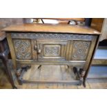 A 17th century style carved oak side cabinet, 92 cm wide, and an Art Nouveau oak upright bureau,