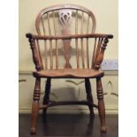 A Windsor style yew and elm stick back armchair, with a crinoline stretcher and turned legs
