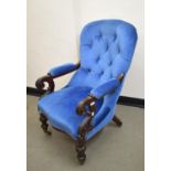 A Victorian button back upholstered armchair, with carved decoration