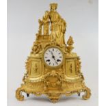 A 19th century French mantel clock, the 7.5 cm diameter enamel dial with Roman numerals, fitted an