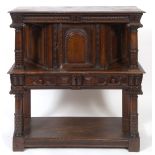 A 17th century style carved oak buffet, having a panel door, geometric carved drawer, and an