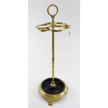 A brass six division stick stand, on a circular base, 59 cm high
