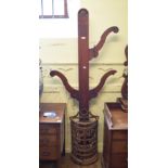 A cast iron stick stand, of demi lune form with stylised floral and foliate decoration, with an