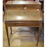 An Edwardian inlaid mahogany cylinder desk, on tapering square legs joined by a shaped undertier, 75