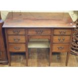 An Edwardian inlaid mahogany kneehole table, with seven drawers, 107 cm wide