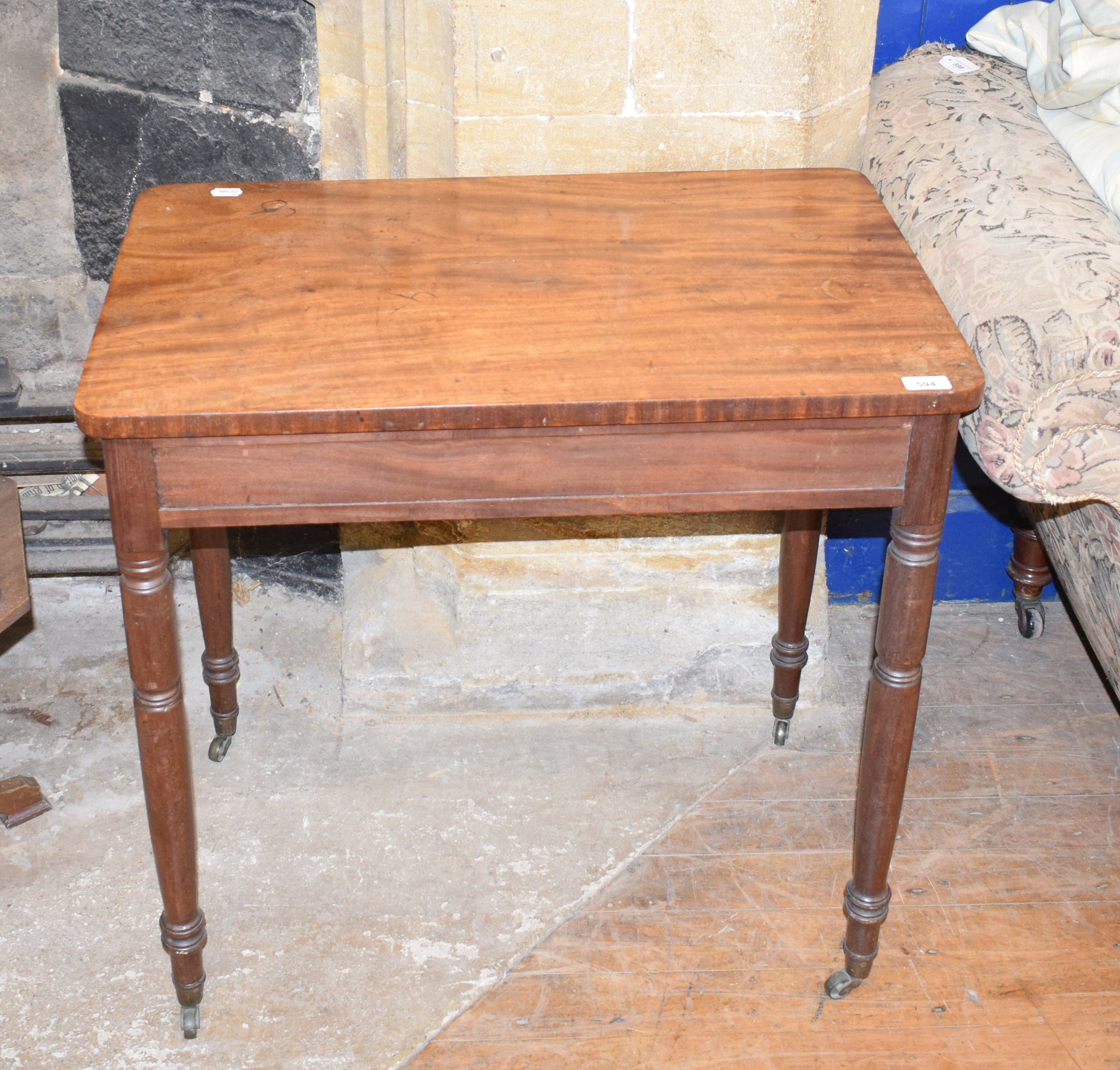 A Victorian mahogany writing table, on turned legs, 76 cm wide