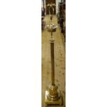 A late 19th/early 20th century brass standard lamp, with a reeded column, adapted for electricity,