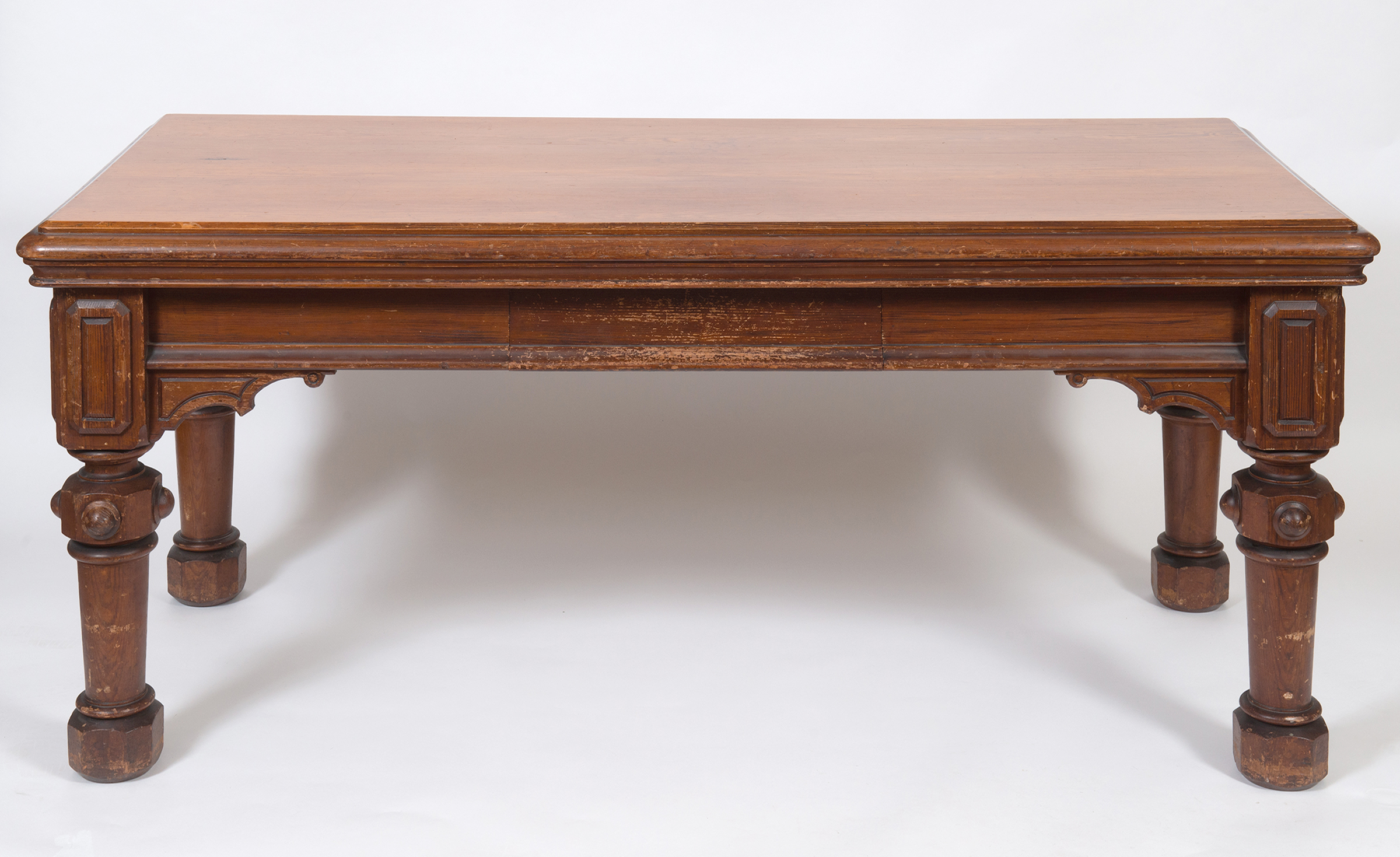 A late Victorian gothic style pine table, on carved and tapering legs, 183 cm wide See illustration