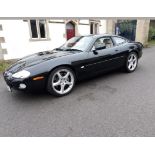 A 2002 Jaguar XKR Coupé, registration number E9 LCH, black. Introduced in 1998 the supercharged