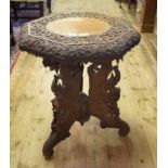 A Burmese carved teak table, with an octagonal top, 50 cm diameter