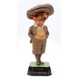 An early 20th century painted wood advertising figure, in the form of a golfer smoking a pipe,