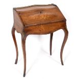 A French rosewood bonheur du jour, with a brass three quarter gallery and fall front with floral