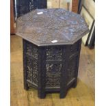 An Eastern carved hardwood table, with an octagonal top, 49 cm wide