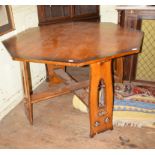A Gothic style oak octagonal table, the supports with pierced decoration, 126 cm wide