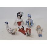 A porcelain figure of a bather, 16.5 cm wide, and four other figures (5) Modern