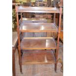 A mahogany four tier whatnot, on turned legs, 69 cm wide Dimensions are: 69 cm wide 38 cm deep 125