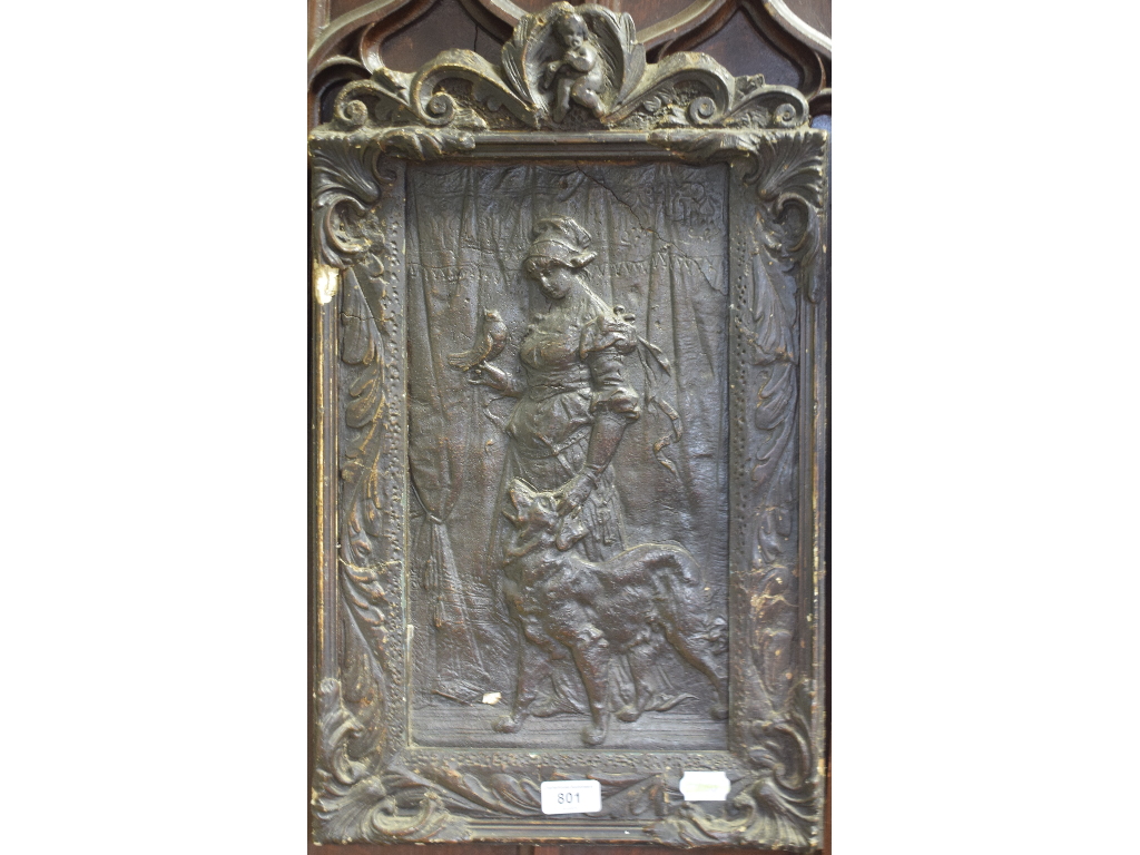 A moulded composition panel, of a lady with a dog, with a bird perched on her hand, within a frame