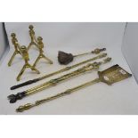 A set of three 19th century brass fire irons, a similar pair of stands and a brush (6)