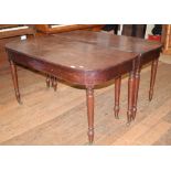 An early 19th century mahogany dining table, inset two extra leaves, on tapering turned legs, 229 cm
