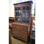 A mahogany secretaire bookcase, the moulded cornice above a pair of lancet bar glazed doors, the