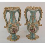 A pair of two handled porcelain vases, each decorated a landscape, 25 cm high (2)