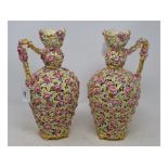 A pair of Zsolnay reticulated vases with handles, decorated flowers and foliage, on four splay