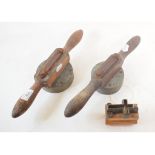 Two brass and treen moulds, possibly for making biscuits, and a similar crucifix mould (3)