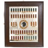 An early 20th century Kynoch shotgun cartridge display mirror, comprising an arrangement of Kynoch