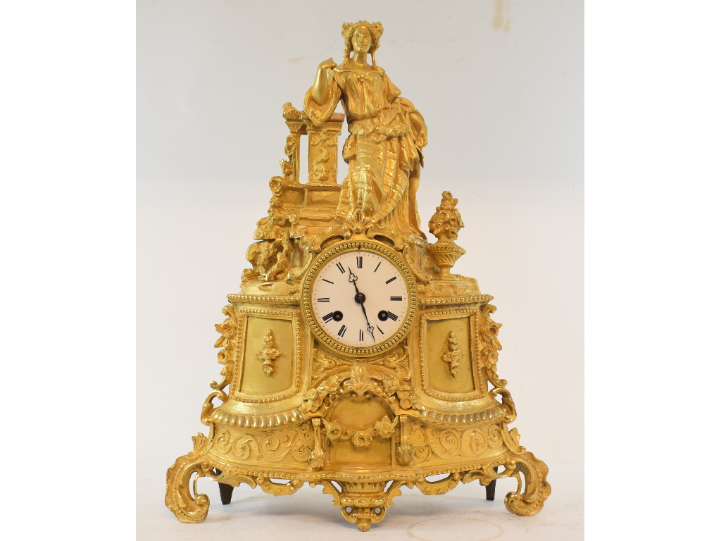 A 19th century French mantel clock, the 7.5 cm diameter enamel dial with Roman numerals, fitted an