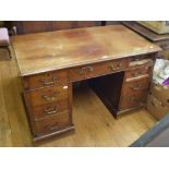 A mahogany pedestal desk, having an arrangement of nine drawers, 122 cm wide